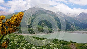 Big Almaty lake in the mountains. Green hill.