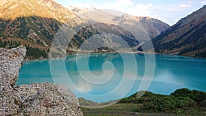 Big Almaty lake in the mountains. Green hill.