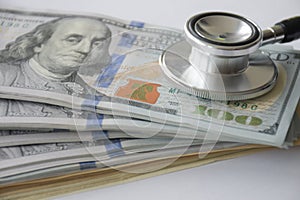 Big amount cash money with stethoscope as for health care and financial