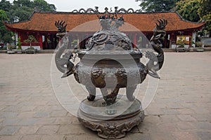 A Big antique bronze incense burner with the House of Ceremonies in the background at Temple of Literature Original built in 1070