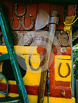 Big ax on a colored wall with horseshoes