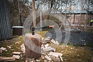 An big axe is stuck in a thick log