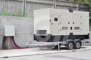 Big Backup Diesel Generator for Office Building Ð¡onnected to the the Control Panel with Cable Wire