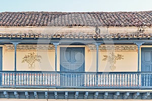 Big balcony with wooden railings of colonial Spanish style house in historic center Trinidad, Cuba