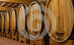 Big barrels with wine in winery cellar