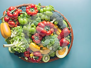 A big basket many type of fresh vegetables green background