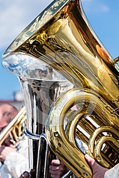 big bass tuba during open air concert against blue sky background