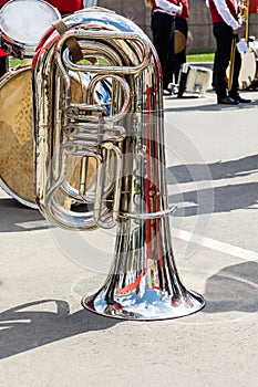 big bass tuba on pavement background during the break of orchestra performance. music instruments closeup.