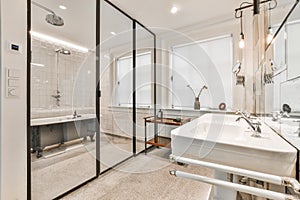 Big bathroom with soaker tub behind glass wall