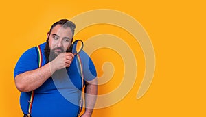 Big bearded funny man with a magnifying lens looking for