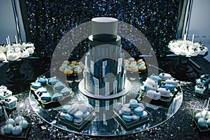 big beautiful black wedding cake stands on a table close up