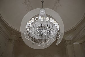 Big crystal chandelier in the wedding hall photo