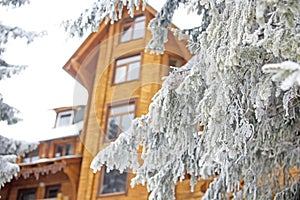 Big beautiful wooden house in the snowy woods in winter