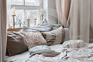 Big bed with baldachin and many pillows photo