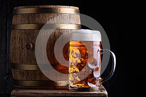 Big beer mug and beer barrel on wooden table