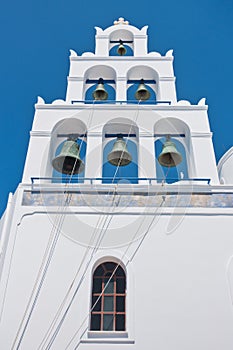 Big bell tower with 6 bells of Panagia church at Oia village at Santorini island