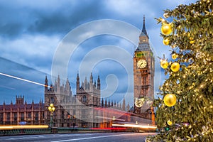 Big Ben with Christmas tree on bridge in the evening, London, England, United Kingdom