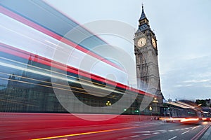 Big Ben in the early morning and red bus passing in London