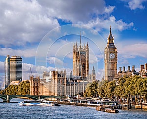 Big Ben and Houses of Parliament with boats on the river in London, England, UK