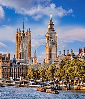 Big Ben and Houses of Parliament with boats on the river in London, England, UK