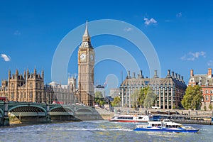 Big Ben and Houses of Parliament with boats on the river in London, England, UK