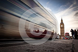 Big Ben, the Palace of Westminster, red bus and tourists moving, London, UK