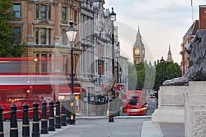 Big Ben with red London bus seen from Trafalgar square