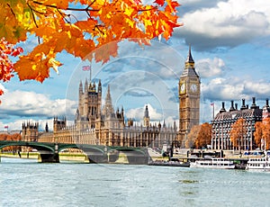 Big Ben tower with Houses of Parliament and Westminster bridge in autumn, London, UK