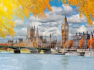 Big Ben tower with Houses of Parliament and Westminster bridge in autumn, London, UK