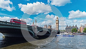 Big Ben, Westminster Bridge with red bus on River Thames in London, the UK.