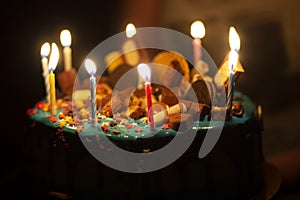 Big birthday cake with cream and candles for the birthday in the hands