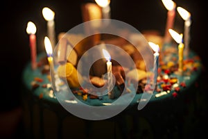 Big birthday cake with cream and candles for the birthday in the hands