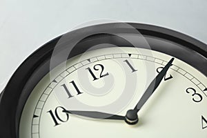 Big black clock, closeup. Time change