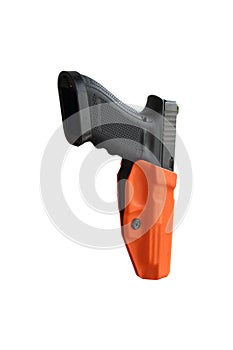 Big black gun pistol in orange envelope isolated on white background