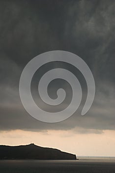 Big black storm clouds over land and sea