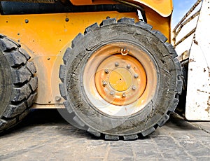 Big black tyre on a commercial industrial excavator machinery.