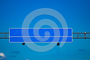 Big blank highway road sign with gradient blue sky