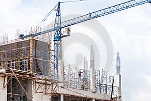 Big blue crane in building construction site
