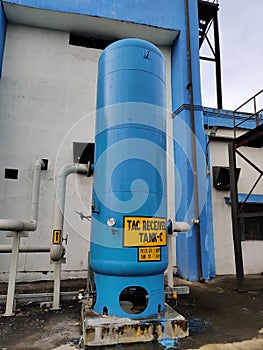 A big blue industrial receiver tank