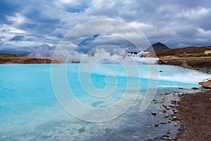 Big blue steaming lake, cloudy sky geothermal area Iceland