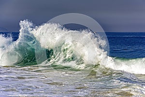 Big blue wave breaking on Ipanema beach