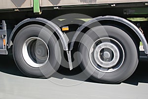 Big blurred lorry wheels on the move