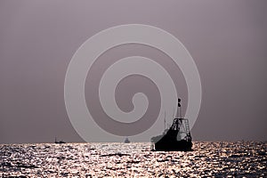 the big boat going somewhere in an ocean at the evening time