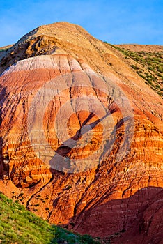 Big Bogdo mountain. Red sandstone outcrops on the slopes sacred mountain in Caspian steppe Bogdo - Baskunchak nature reserve,