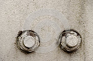 big bolt and nut closeup. Metal construction and threaded connection. Gray background. The basis of the iron electricity pylon