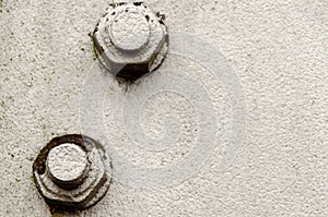 big bolt and nut closeup. Metal construction and threaded connection. Gray background. The basis of the iron electricity pylon