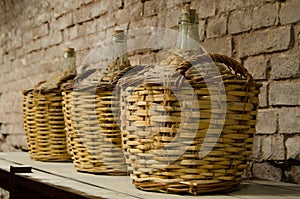 Big bottle in a cellar with aged alcohol