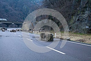 Big boulders fall on the mainroad, road is close photo