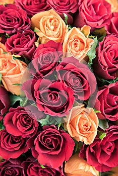 Big bouquet of red and orange roses. Top view as background.