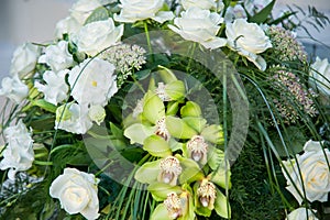 Big bouquet of white roses, yellow daffodils, greenery and lotuses